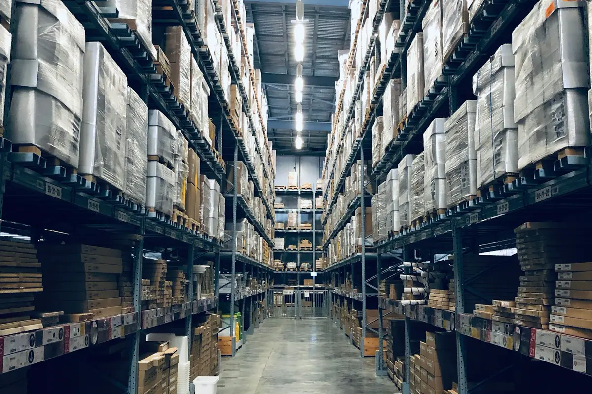 Warehouse aisle lined with pallet racking and boxed inventory