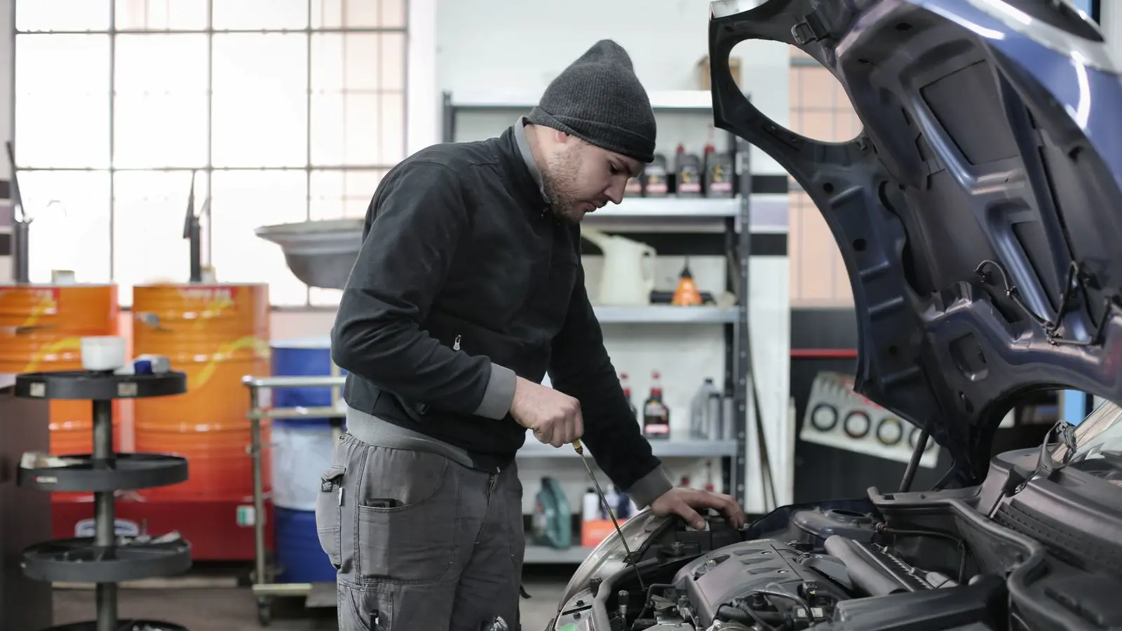 Technician inspecting an engine in an independent auto service shop