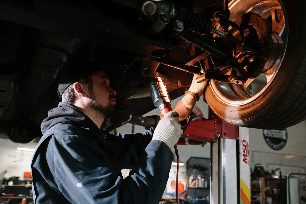 Technician working in a service bay, representing workplace injury exposure